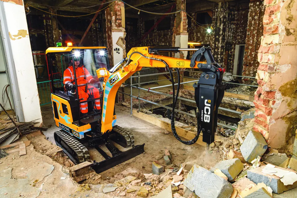 A JCB carrying out internal works on an inside construction site.