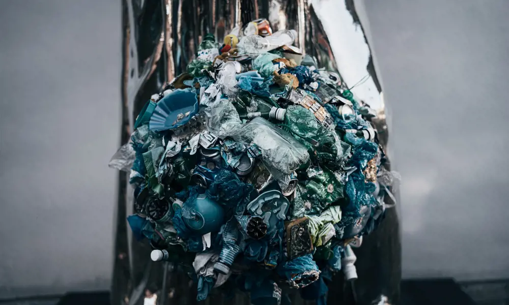 A mass of crushed plastic bottles and other waste items.
