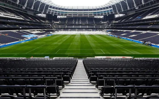 The empty chairs and football field at Tottenham Hotspur Stadium.