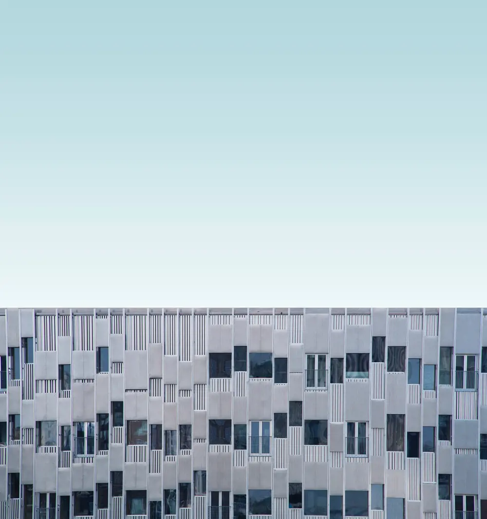 A graphic depicting the top few floors of a building, against a pastel background resembling a light sky.