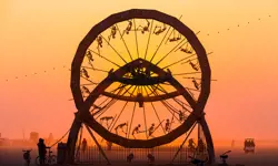 The Charon Zoetrope is pictured against a red sky, with all of its skeletons around the edge visible in silhouette form.