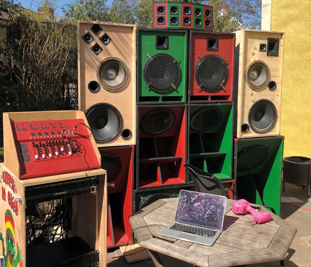 A soundsystem made from wood, painted red and green with "Hertz So Good" on the side.