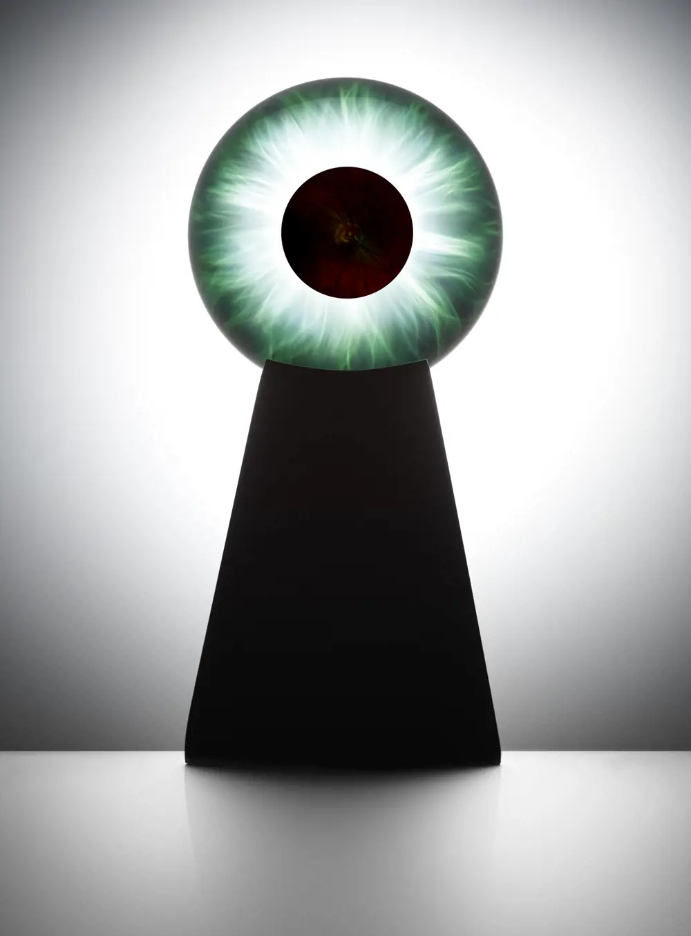 A keyhole shape with a black bottom half and a round top half that looks like an eye