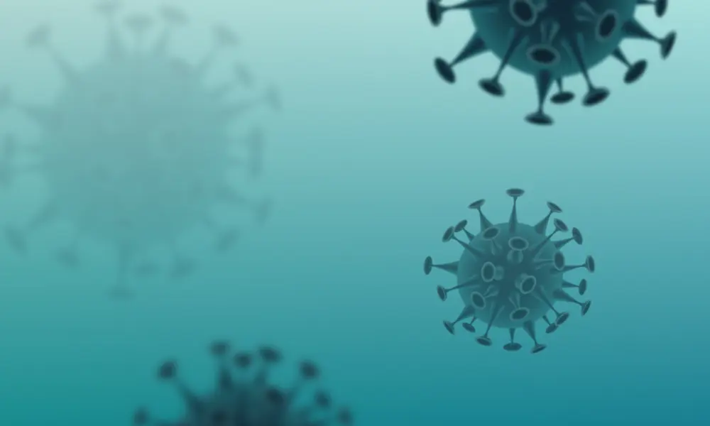An illustration of floating circular virus particles with long spikes on the outside.