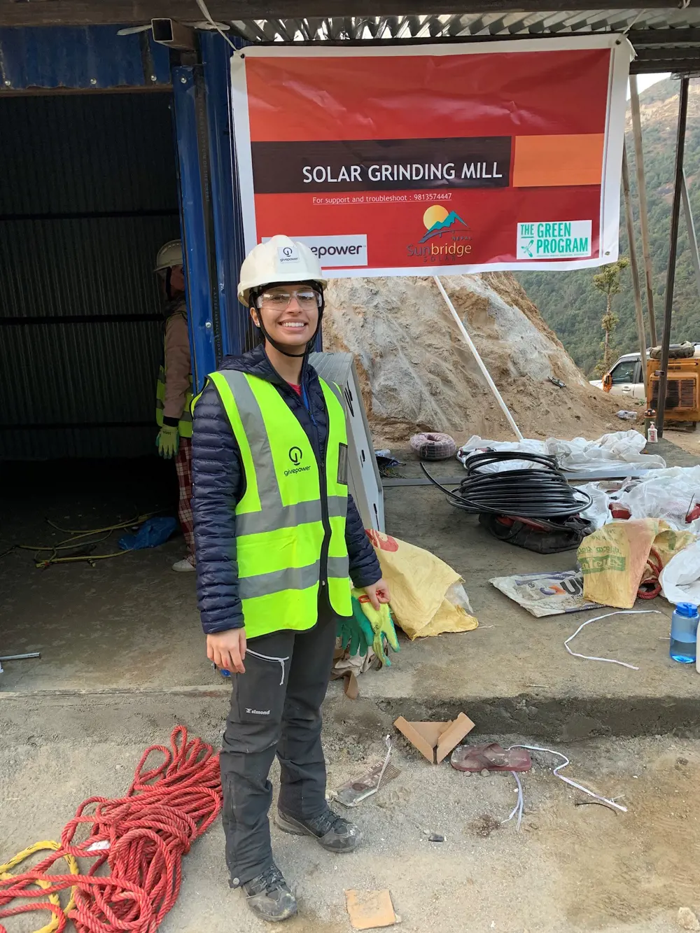 A female engineer onsite at a solar powered grinding mill.