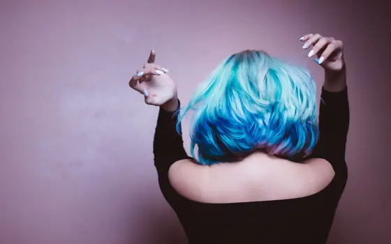 A person with blow-dried blue and pink hair