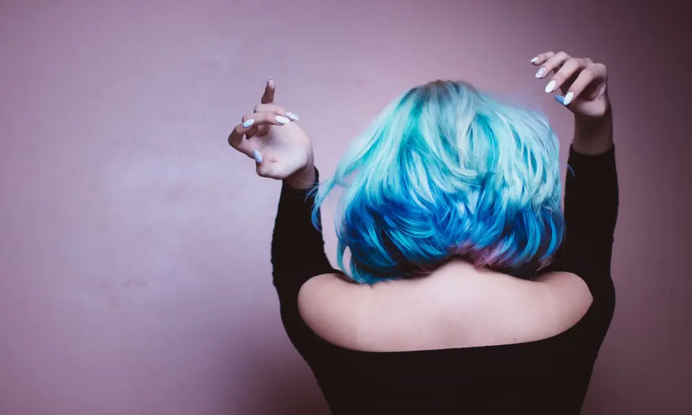 A person with blow-dried blue and pink hair