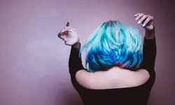 A person with blow-dried blue and pink hair