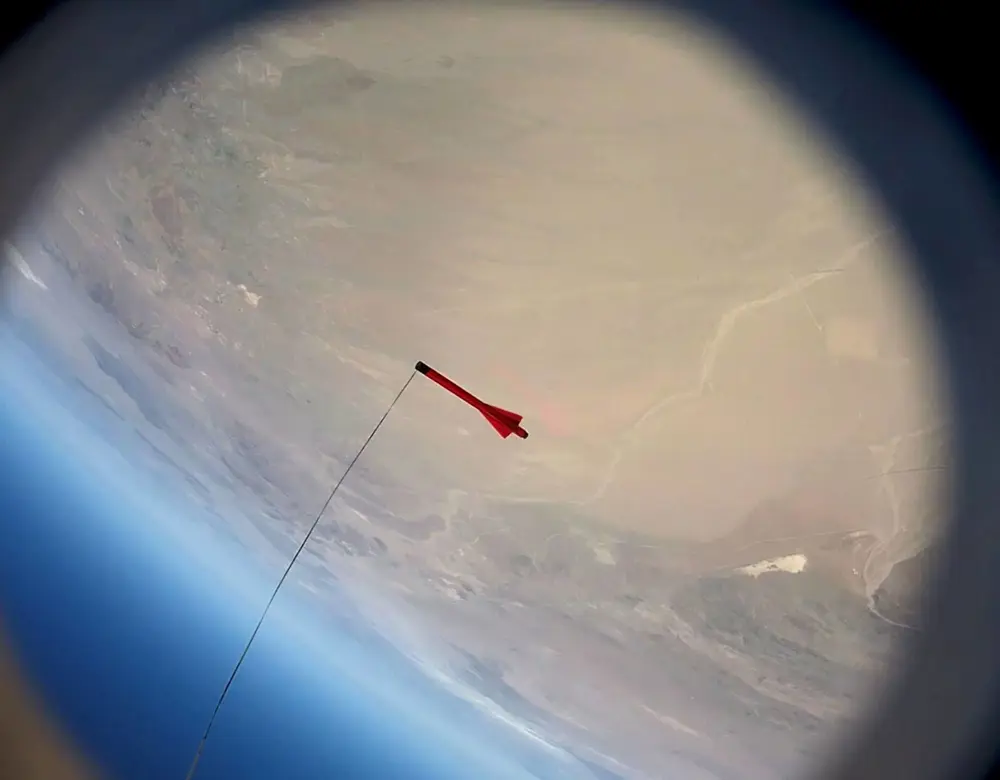Project Sunride's Karman Charlie rocket photographed above the Earth from high altitude.