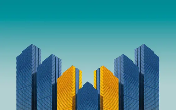 A mirrored graphic of four buildings, coloured in blue and yellow.