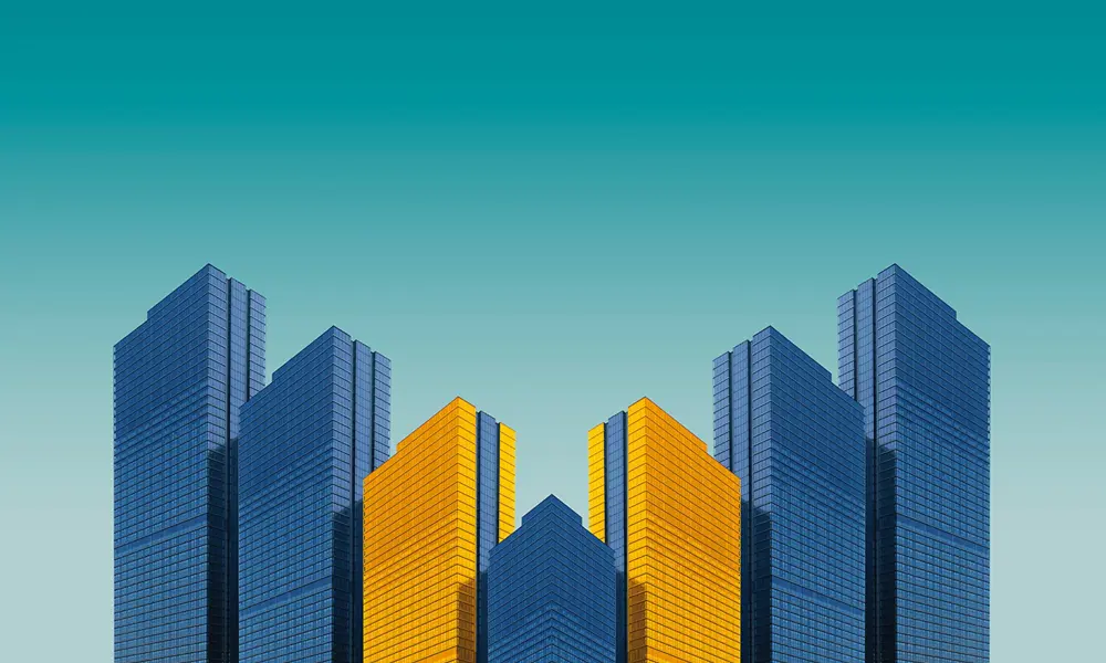 A mirrored graphic of four buildings, coloured in blue and yellow.