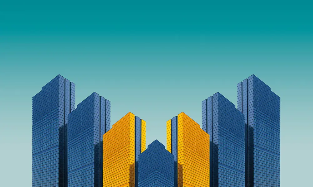 A mirrored graphic of four buildings, coloured in blue and yellow.