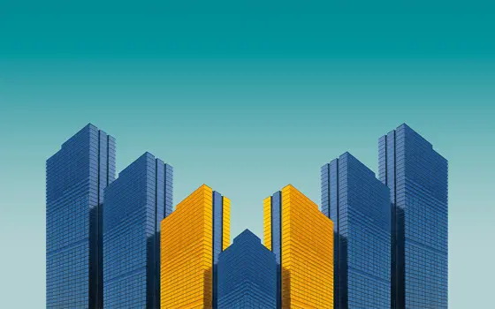 A mirrored graphic of four buildings, coloured in blue and yellow.