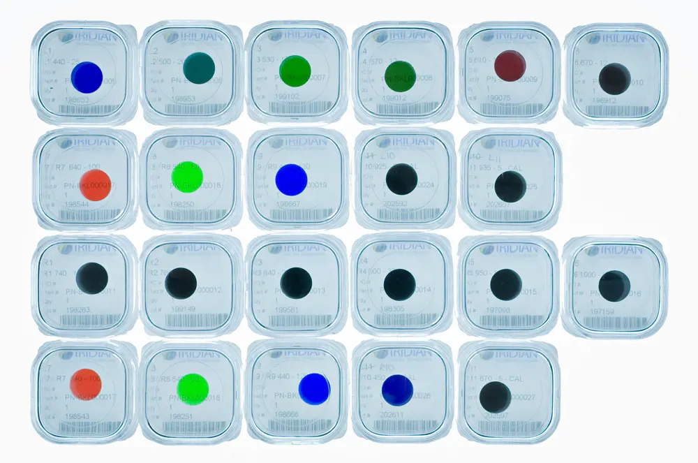 Square filters for the ExoMars rover in their transport cases with different coloured dots on them arranged in rows.