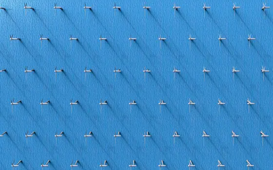 A digital rendering of an array of wind turbines at sea.