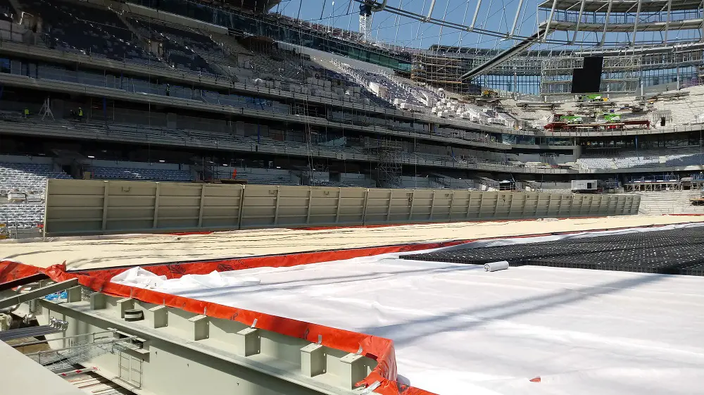 The NFL pitch when it is not in use, with pitch sections not visible and the torch line structure that has been lowered to ground level.