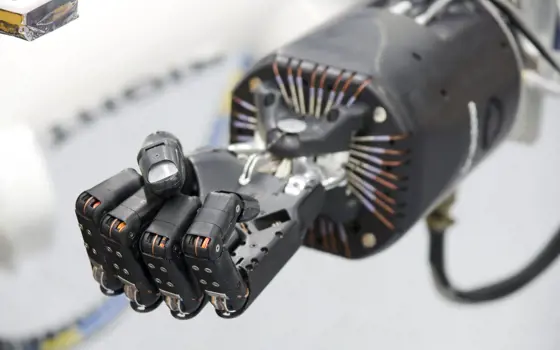 A close up of a robotic hand, clenched.