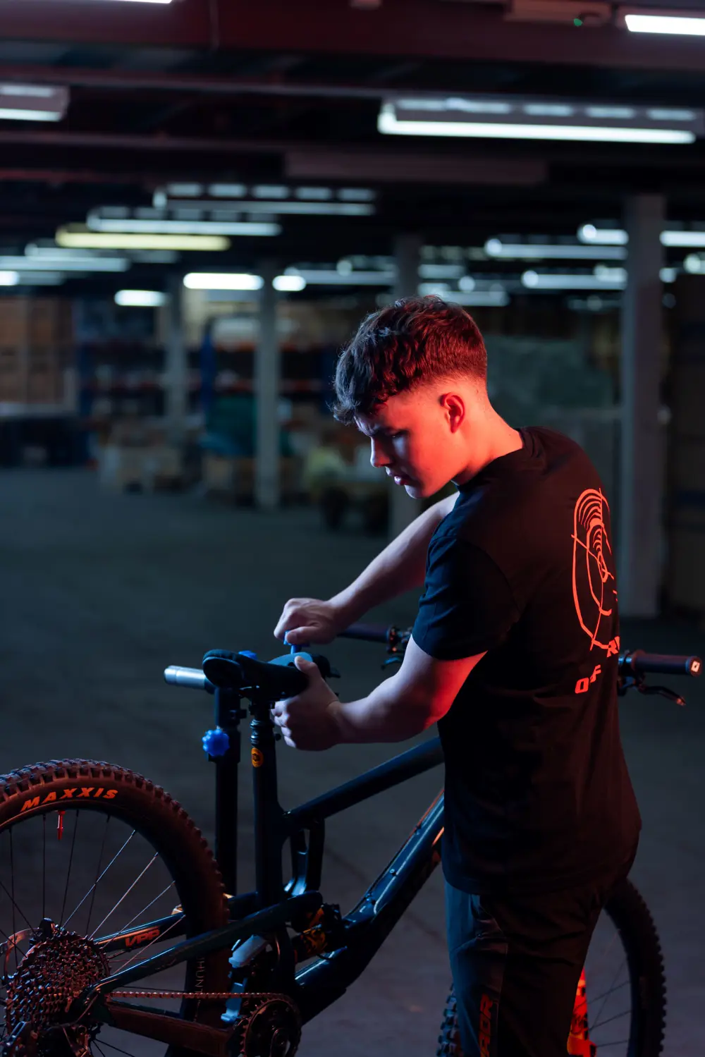 Harvey Hudson adjusting the seat of his mountain bike.